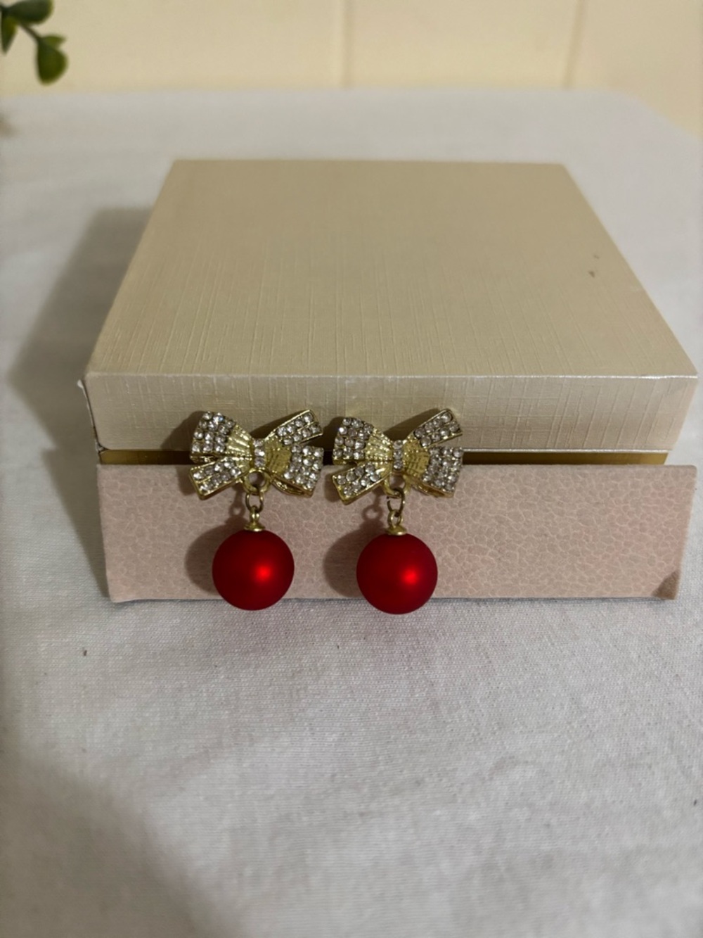 Gold Bow Drop Earrings with Red Bead Accent